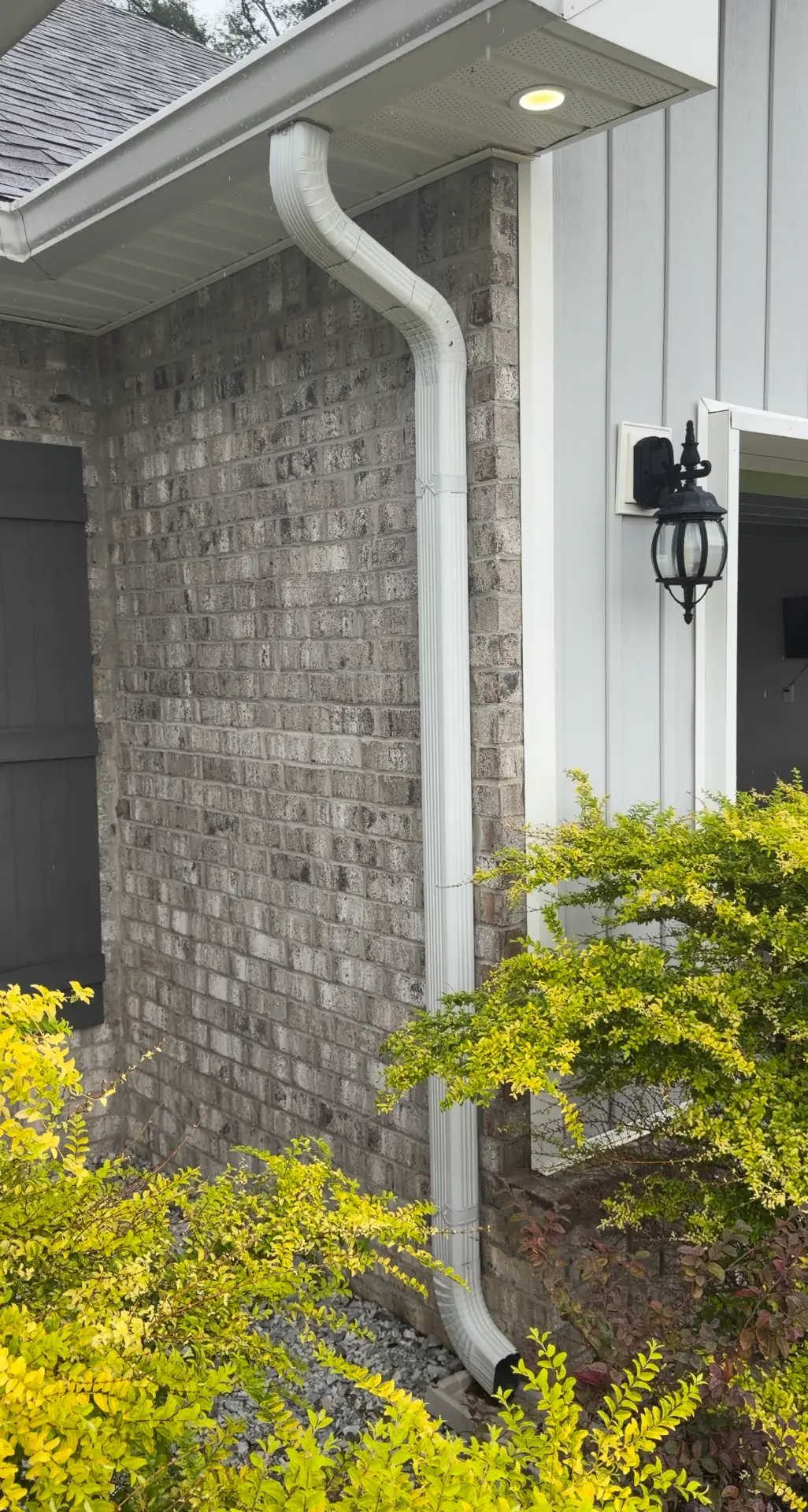 White gutter and downspout installed by Gutter Gurus